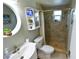Updated bathroom with a modern vanity, toilet, and tiled shower with a window at 3839 Star Island Dr, Holiday, FL 34691