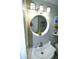 Clean bathroom featuring a modern sink, a round mirror, and updated light fixtures at 3839 Star Island Dr, Holiday, FL 34691