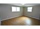 Bright bedroom with hardwood floors, white trim, and plenty of natural light at 3839 Star Island Dr, Holiday, FL 34691