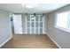 Bedroom with hardwood floors, sliding closet door, and bright natural light at 3839 Star Island Dr, Holiday, FL 34691