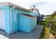 Side view of the quaint home showcasing a backyard shed and well-maintained surroundings at 3839 Star Island Dr, Holiday, FL 34691