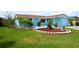 Lush front yard and quaint home create a welcoming scene, perfect for comfortable living at 3839 Star Island Dr, Holiday, FL 34691