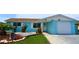 Charming single-story home with blue exterior, well-maintained landscaping, and an attached garage at 3839 Star Island Dr, Holiday, FL 34691
