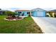 Cozy single-story home with a landscaped front yard and paved driveway leading to a covered entry at 3839 Star Island Dr, Holiday, FL 34691
