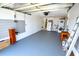 Spacious two-car garage with a utility area that includes a washer and dryer, refrigerator, and storage space at 3839 Star Island Dr, Holiday, FL 34691