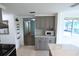 Kitchen with gray cabinets, white countertops and stainless steel appliances at 3839 Star Island Dr, Holiday, FL 34691