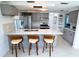 Modern kitchen with stainless steel appliances, white countertops, and stylish pendant lighting at 3839 Star Island Dr, Holiday, FL 34691