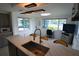Bright kitchen featuring modern countertops, stainless sink, and ample natural light from surrounding windows at 3839 Star Island Dr, Holiday, FL 34691