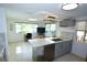 Bright kitchen with marble countertops, gray cabinets, and a view of the water at 3839 Star Island Dr, Holiday, FL 34691