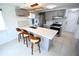 Well-lit kitchen with island, marble countertops, stainless steel appliances, and a breakfast bar at 3839 Star Island Dr, Holiday, FL 34691