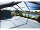 Spacious screened lanai overlooking the water and boat dock, providing a tranquil outdoor retreat at 3839 Star Island Dr, Holiday, FL 34691