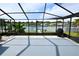 Well-maintained screened lanai offering views of the lake and lush landscaping at 3839 Star Island Dr, Holiday, FL 34691