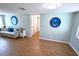 Spacious living room with wood-look flooring, coastal decor, and ample natural light throughout at 3839 Star Island Dr, Holiday, FL 34691