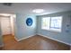 Inviting living room with wood floors, recessed lighting, a modern circular art piece, and a large window at 3839 Star Island Dr, Holiday, FL 34691