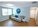 Comfortable living room featuring modern decor, wood floors, and a window for natural light at 3839 Star Island Dr, Holiday, FL 34691