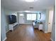 Open living room with wood floors, blue walls, and plenty of natural light at 3839 Star Island Dr, Holiday, FL 34691
