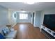 Spacious living room with hardwood floors, neutral walls and a comfortable seating area at 3839 Star Island Dr, Holiday, FL 34691
