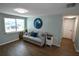 Inviting living room featuring a comfortable couch, accent pillows, and wood-look tile flooring at 3839 Star Island Dr, Holiday, FL 34691