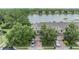 Aerial view of townhouses with a lake backdrop, showcasing the community's scenic surroundings at 3922 Silverlake Way, Wesley Chapel, FL 33544