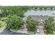 Scenic aerial view of townhouses near a tranquil lake, surrounded by lush greenery at 3922 Silverlake Way, Wesley Chapel, FL 33544