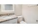 Powder room features stylish fixtures and granite vanity at 3922 Silverlake Way, Wesley Chapel, FL 33544