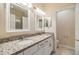 Bathroom features double sinks with granite countertops, modern lighting, and a framed mirror at 3922 Silverlake Way, Wesley Chapel, FL 33544