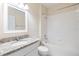 Bathroom featuring a single sink with granite countertop, and a bright white tiled shower-tub combo at 3922 Silverlake Way, Wesley Chapel, FL 33544
