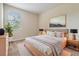 Well-lit bedroom with large window, neutral tones, modern decor, and bed with stylish linens at 3922 Silverlake Way, Wesley Chapel, FL 33544