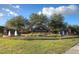 Community entrance sign with 'Seven Oaks' inscription, beautiful landscaping, fountains and blue sky at 3922 Silverlake Way, Wesley Chapel, FL 33544
