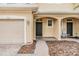 Welcoming front entrance with covered porch and brick walkway to the front door at 3922 Silverlake Way, Wesley Chapel, FL 33544