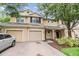 Inviting townhome featuring a brick driveway and front lawn with beautiful landscaping at 3922 Silverlake Way, Wesley Chapel, FL 33544