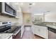 Open concept kitchen with stainless steel appliances and stone countertops at 3922 Silverlake Way, Wesley Chapel, FL 33544