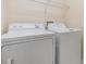 Functional laundry area with white washer and dryer set for convenient home chores at 3922 Silverlake Way, Wesley Chapel, FL 33544