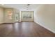Spacious living room with hardwood floors and windows allowing plenty of natural light at 3922 Silverlake Way, Wesley Chapel, FL 33544