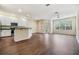 Bright and airy living area features hardwood floors, and a kitchen breakfast bar at 3922 Silverlake Way, Wesley Chapel, FL 33544