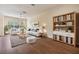 Comfortable living room features hardwood floors, a bookcase, and a ceiling fan at 3922 Silverlake Way, Wesley Chapel, FL 33544