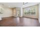 Large living room area featuring hardwood floors, an outdoor patio door, and bright windows at 3922 Silverlake Way, Wesley Chapel, FL 33544