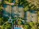 Aerial view of community tennis courts surrounded by lush greenery and walking paths at 3922 Silverlake Way, Wesley Chapel, FL 33544