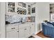 This home features a stylish bar area with custom cabinets, granite counters and subway tile backsplash at 4049 Wellington Pkwy, Palm Harbor, FL 34685