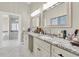 Bathroom featuring dual sinks, vanity, and granite countertop with a view into the shower and tub at 4049 Wellington Pkwy, Palm Harbor, FL 34685