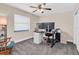 Comfortable bedroom featuring soft gray carpet, neutral paint, and ample natural light at 4049 Wellington Pkwy, Palm Harbor, FL 34685
