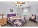 Cozy bedroom featuring a soft color palette, ceiling fan, and coordinated furnishings at 4049 Wellington Pkwy, Palm Harbor, FL 34685
