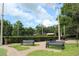 Inviting community area with benches, picnic tables, and a lush green space for relaxation and enjoyment at 4049 Wellington Pkwy, Palm Harbor, FL 34685