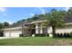 Charming home with a well-maintained lawn and a convenient attached three-car garage at 4049 Wellington Pkwy, Palm Harbor, FL 34685