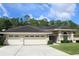 Beautiful house has a three-car garage and a well-manicured lawn at 4049 Wellington Pkwy, Palm Harbor, FL 34685