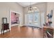 Inviting foyer with hard wood floors, a hanging light fixture, and beautiful millwork at 4049 Wellington Pkwy, Palm Harbor, FL 34685