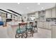 Open floorplan kitchen with seating island overlooking the living area, perfect for entertaining at 4049 Wellington Pkwy, Palm Harbor, FL 34685