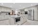 Bright kitchen featuring a large center island with stainless steel microwave and modern appliances at 4049 Wellington Pkwy, Palm Harbor, FL 34685