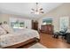 Comfortable main bedroom featuring a vaulted ceiling, dresser, and sliding glass doors at 4049 Wellington Pkwy, Palm Harbor, FL 34685