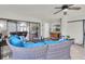 Covered patio with comfortable wicker seating, ceiling fan, and sliding glass doors to the interior at 4049 Wellington Pkwy, Palm Harbor, FL 34685